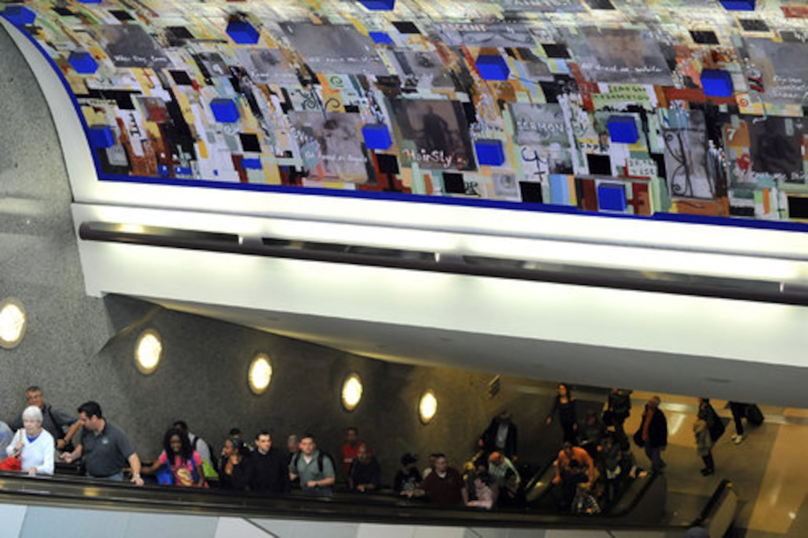 Radcliff Bailey's piece "Saints," a collage of older black and white photos of people, words and phrases, crosses and colors, was installed at Hartsfield-Jackson Airport for the 1996 Olympics.