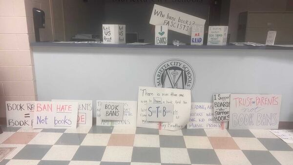 These were some of the signs Marietta school district parents and students brought to a Sept. 12, 2023, meeting to share their feelings about a plan to review the district's books for material that is considered sexually explicit. (Eric Stirgus / eric.stirgus@ajc.com)