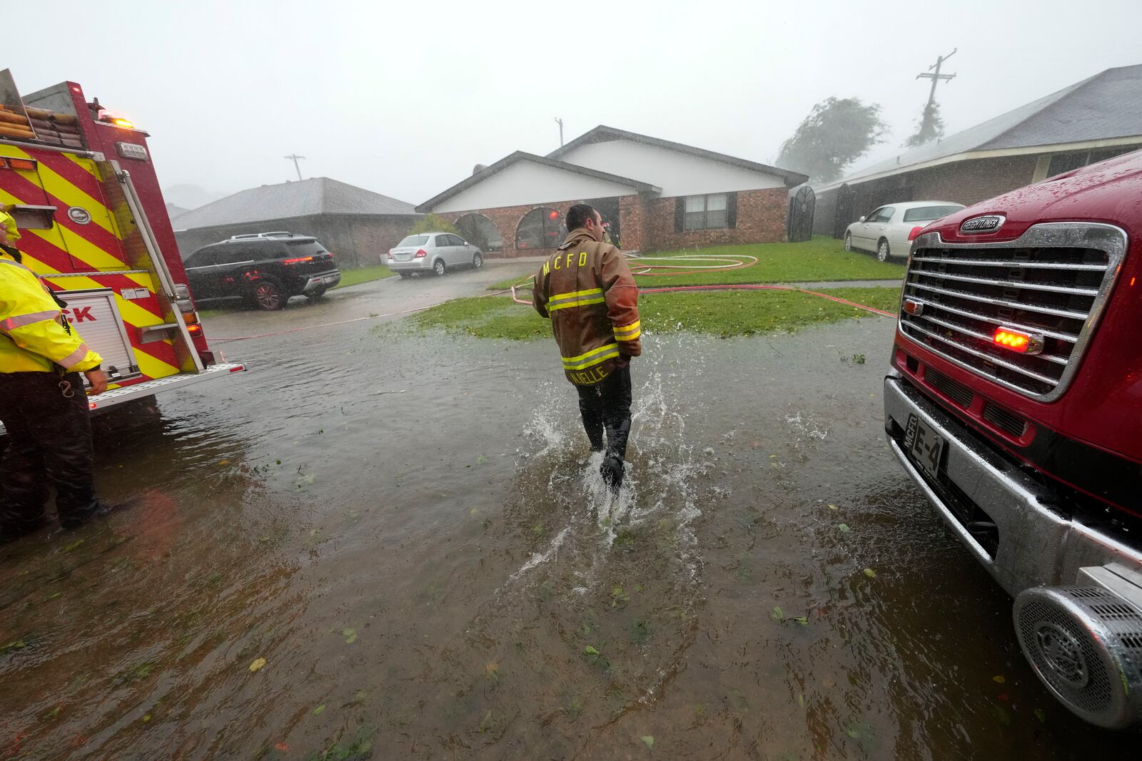 Morgan City firefighters respond to a home fire during Hurricane Francine in Morgan City, La., Wednesday, Sept. 11, 2024. (AP Photo/Gerald Herbert)