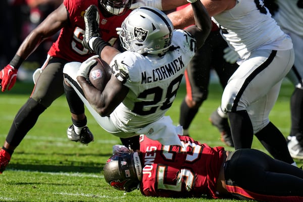 Tampa Bay Buccaneers linebacker Vi Jones (53) tackles Las Vegas Raiders running back Sincere McCormick (28) during the second half of an NFL football game, Sunday, Dec. 8, 2024, in Tampa, Fla. (AP Photo/Chris O'Meara)