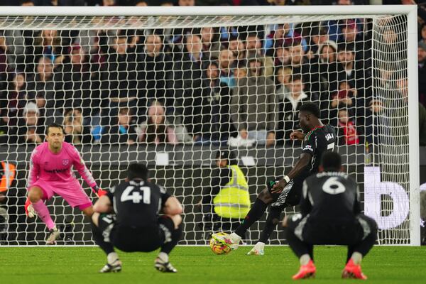 Arsenal's Bukayo Saka scores his side's fifth goal during the English Premier League soccer match between West Ham and Arsenal at the London Stadium in London, Saturday, Nov. 30, 2024. (AP Photo/Dave Shopland)