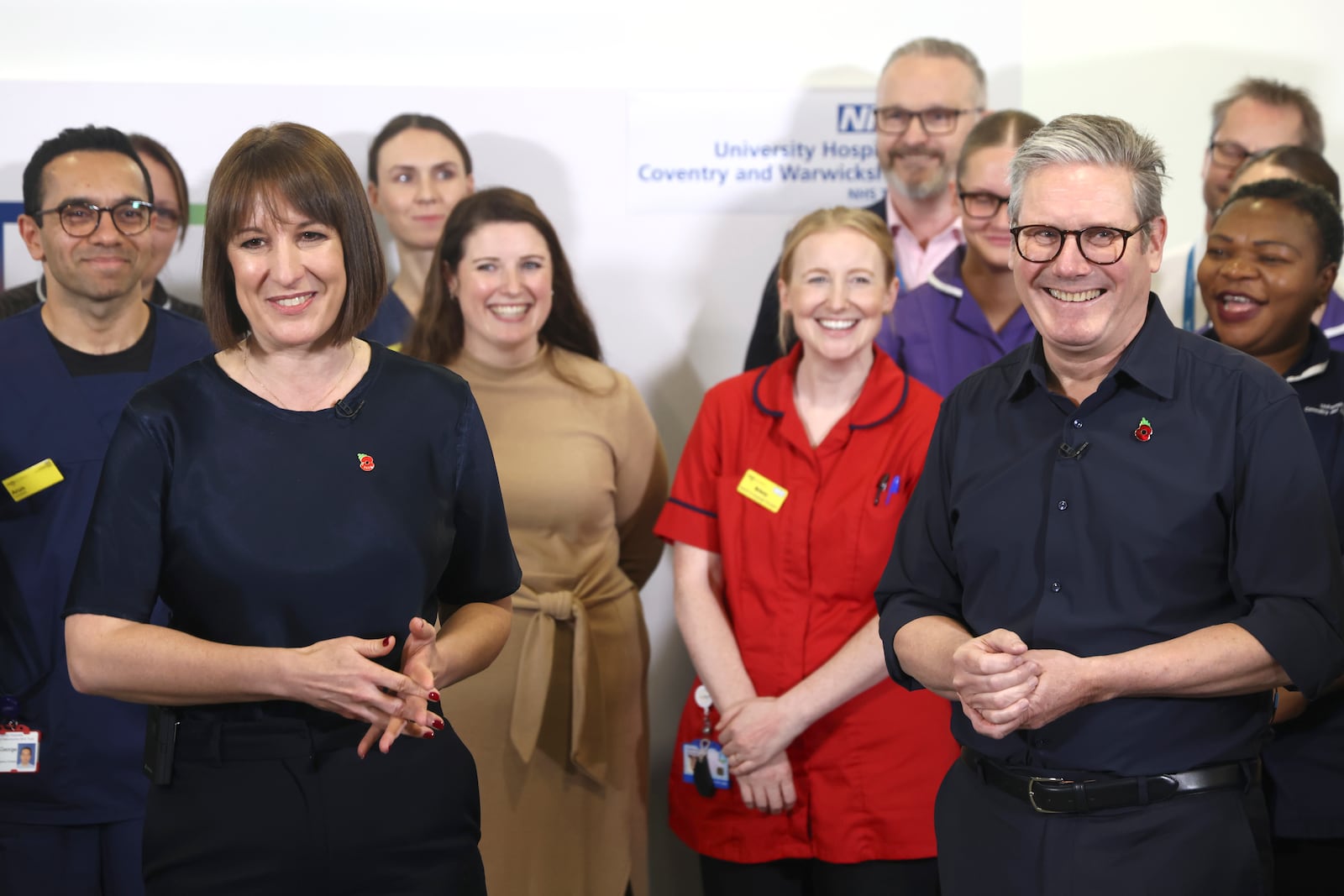 Britain's Prime Minister Keir Starmer and Chancellor Rachel Reeves with members of staff, during a visit to University Hospital Coventry and Warwickshire, in Coventry, England, Thursday, Oct. 31, 2024. (AP Photo/Darren Staples, pool)