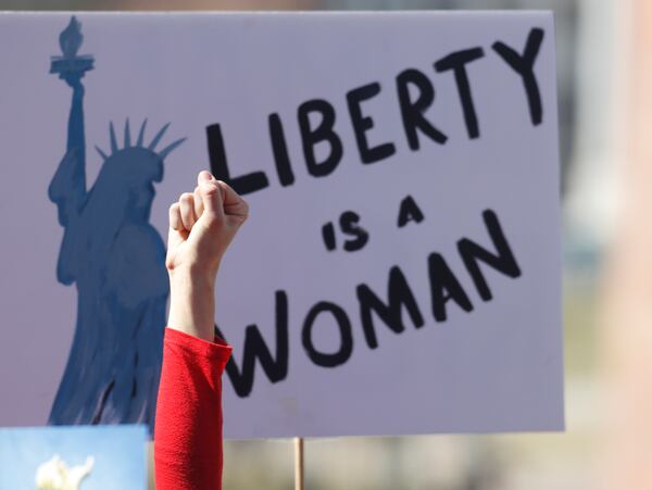 An unidentified participant raises her hand in support of a speaker during  International Women's Day  on Wednesday, March 8, 2017, in Denver. (AP Photo/David Zalubowski)