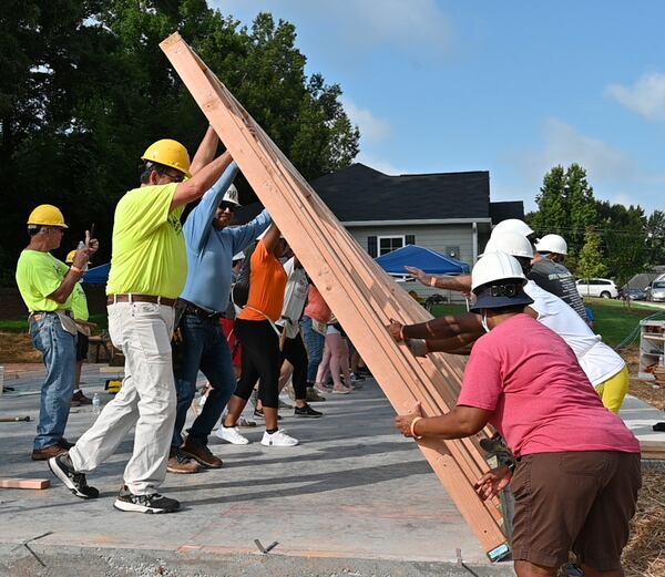 Volunteers raise the first wall for a Habitat home being built in an all-veterans neighborhood in Douglasville. Photo by Dolly Purvis/Habitat for Humanity of Northwest Metro Atlanta