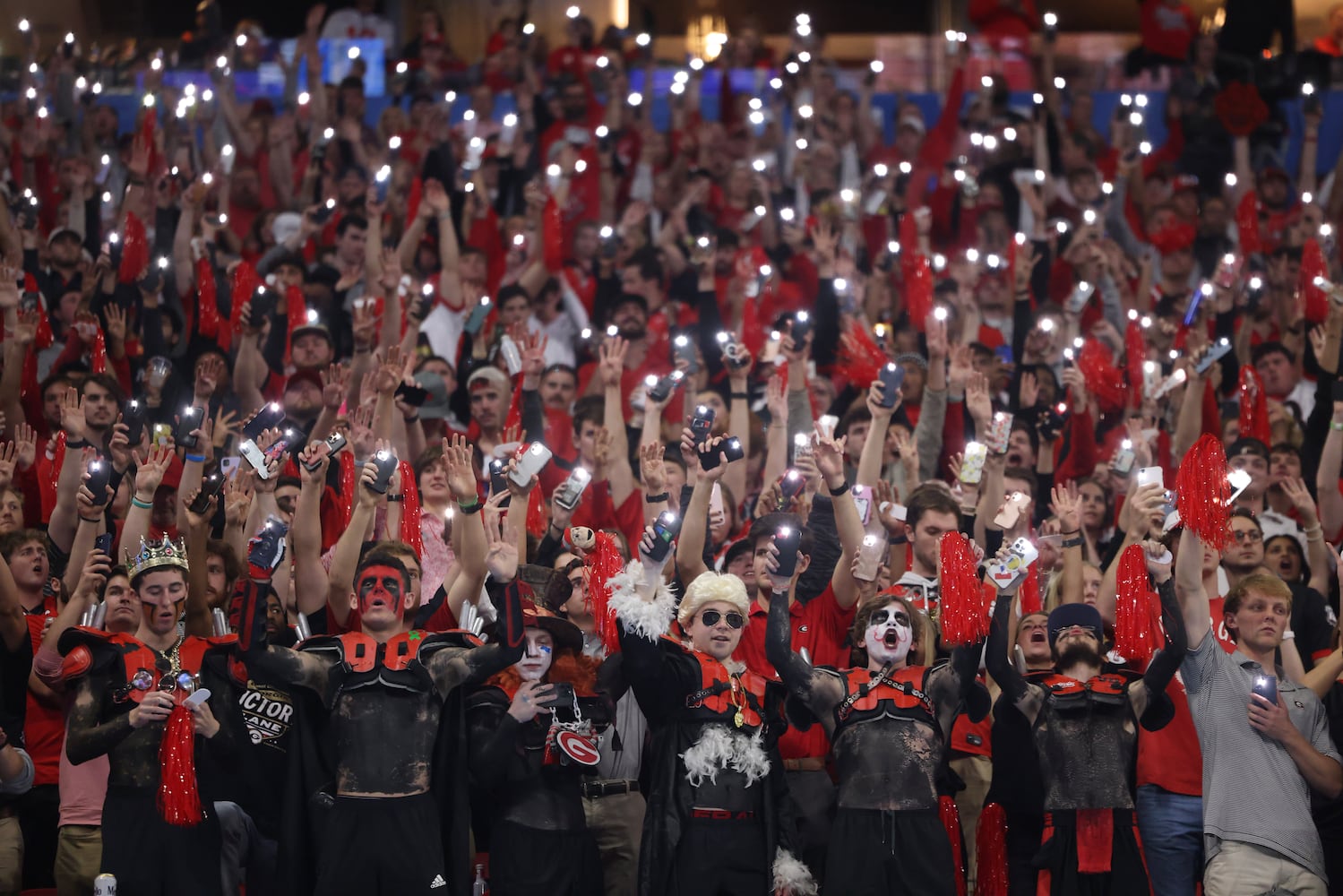 Georgia fans light up the stadium at the start of the fourth quarter of the College Football Playoff Semifinal between the Georgia Bulldogs and the Ohio State Buckeyes at the Chick-fil-A Peach Bowl In Atlanta on Saturday, Dec. 31, 2022.  Georgia won, 42-41. (Jason Getz / Jason.Getz@ajc.com)