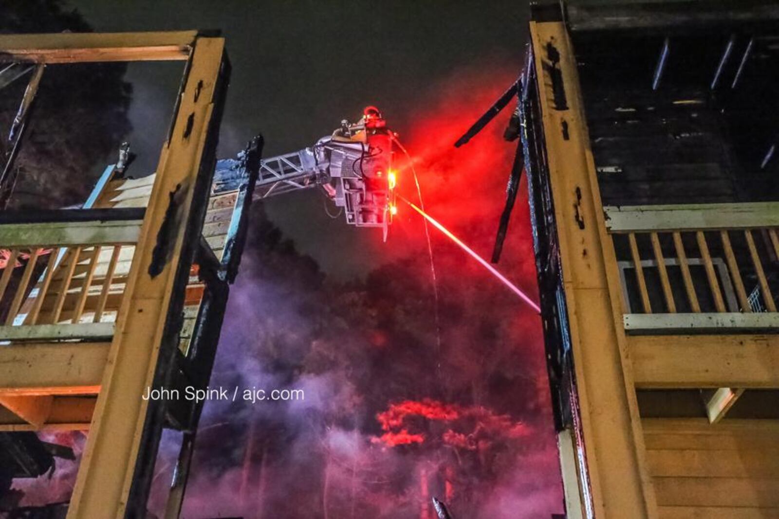 Two fast-moving fires ripped through apartments and condos early Friday near Stone Mountain. JOHN SPINK / JSPINK@AJC.COM