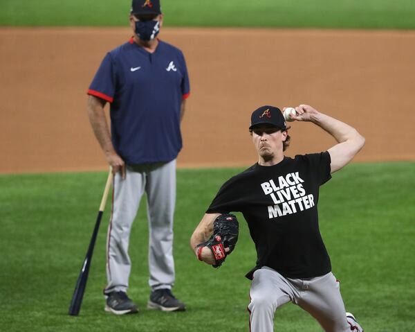 Braves manager Brian Snitker (left) observes NLCS Game 1 starting pitcher Max Fried throws from the mound during team workouts Sunday, Oct. 11, 2020, ahead of the best-of-seven National League Championship Series against the Los Angeles Dodgers at Globe Life Field in Arlington, Texas. (Curtis Compton / Curtis.Compton@ajc.com)