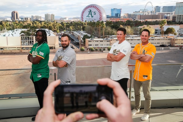 Athletics players, from left, Lawrence Butler, Shea Langeliers, Mason Miller and Brent Rooker pose for a photo as their team's logo is displayed on The Sphere during a press conference, Friday, March 7, 2025, in Las Vegas. (Wade Vandervort//Las Vegas Sun via AP)