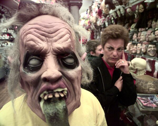 Eddie's Trick Shop on the Marietta Square in October 2009 as 12-year-old Erik Pound was busy finding just the right mask. That's Erik on the left. Erik's mom, Candi Pound, right, appears pretty disgusted at what she sees. PHOTO BY ANDY SHARP/STAFF.