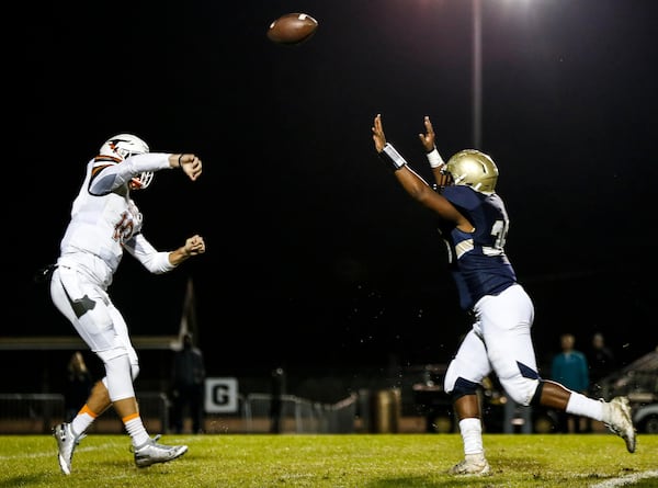 Lanier quarterback Zach Calzada (left) throws a pass against Dacula in 2018. (Casey Sykes for The Atlanta Journal-Constitution)