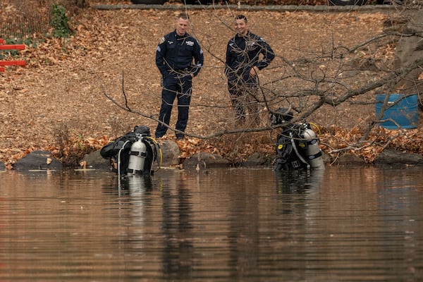 NYPD officers in diving suits search the lake in the Central Park, Monday, Dec. 9, 2024, in New York. (AP Photo/Yuki Iwamura)