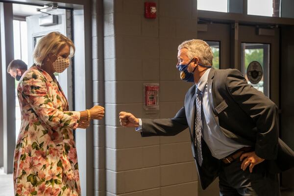 08/25/2020 - Cumming, Georgia - United States Secretary of Education Betsy DeVos (left) greets Forsyth County Schools Superintendent Jeff Bearden with a fist bump during a visit to Forsyth Central High School in Cumming, Tuesday, August 25, 2020. (ALYSSA POINTER / ALYSSA.POINTER@AJC.COM)