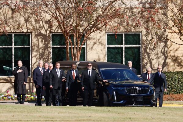 U.S. Secret Service agents accompany the hearse carrying former first lady Rosalynn Carter at Phoebe Sumter Medical Center Monday. (Miguel Martinez/The Atlanta Journal-Constitution/TNS)