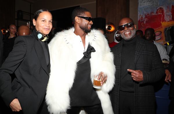 Erica Reid (from left), Usher and L.A. Reid at the Rémy Martin and The House Of Creed Post-Performance Dinner Party At Cathédrale Las Vegas at Cathédral Restaurant on February 11, 2024 in Las Vegas, Nevada. (Photo by Cassidy Sparrow/Getty Images for The House of Creed and Remy Martin)