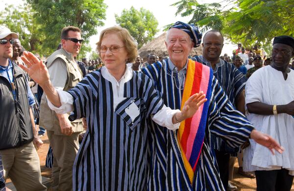 2007: Jimmy and Rosalynn Carter wear traditional Ghanaian attire, a gift from the chief of Tingoli village in northern Ghana, during a field trip to assess Carter Center disease prevention work in Africa. (Carter Center)