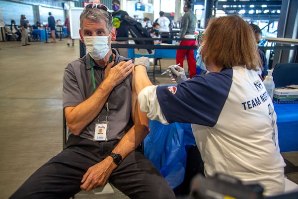 Jeff Gilbert receives a Covid vaccine shot at Truist Park on May 1, 2021. STEVE SCHAEFER FOR THE ATLANTA JOURNAL-CONSTITUTION