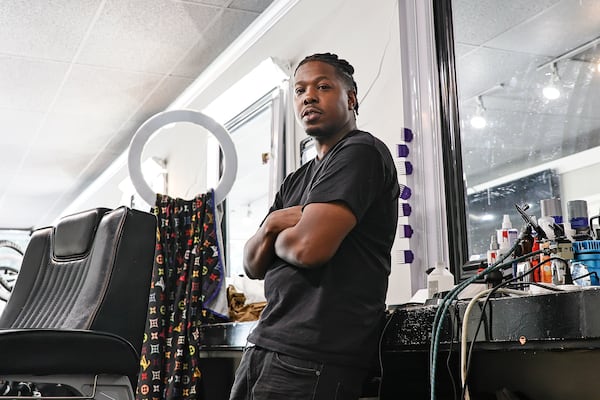 Larry Underwood, also known as SpudCutz, photographed at his booth inside of Anytime Cutz on Cheshire Bridge Road on Wednesday, July 20, 2022. (Natrice Miller/natrice.miller@ajc.com)