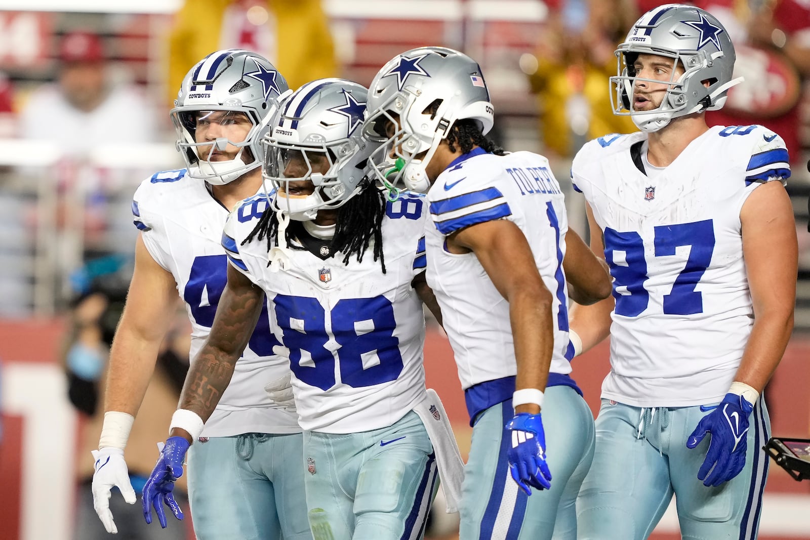 Dallas Cowboys wide receiver CeeDee Lamb (88) celebrates after scoring a touchdown with running back Hunter Luepke, left, wide receiver Jalen Tolbert (1) and tight end Jake Ferguson (87) during the second half of an NFL football game against the San Francisco 49ers in Santa Clara, Calif., Sunday, Oct. 27, 2024. (AP Photo/Tony Avelar)