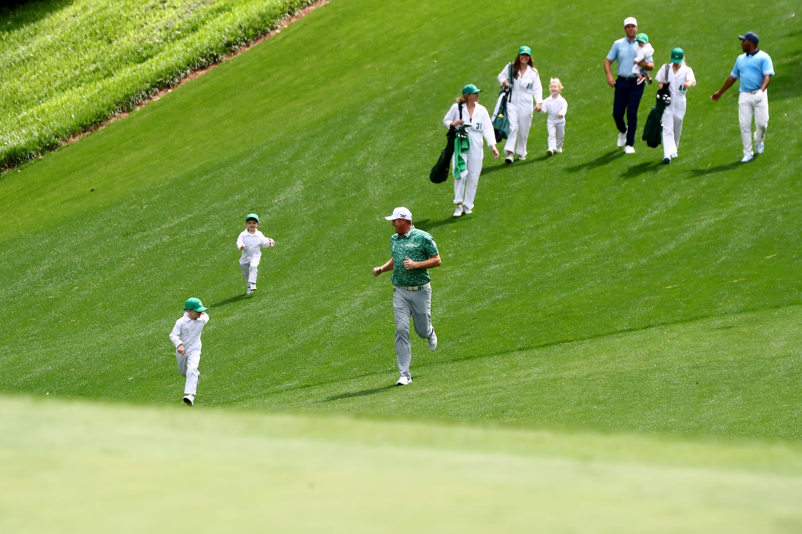 040622 Augusta:  Jason Kokrak runs down the fairway with his sons during the Par 3 Contest of the Masters at Augusta National Golf Club on Wednesday, April 6, 2022, in Augusta. “Curtis Compton / Curtis.Compton@ajc.com”