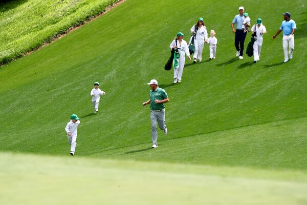 040622 Augusta:  Jason Kokrak runs down the fairway with his sons during the Par 3 Contest of the Masters at Augusta National Golf Club on Wednesday, April 6, 2022, in Augusta. “Curtis Compton / Curtis.Compton@ajc.com”