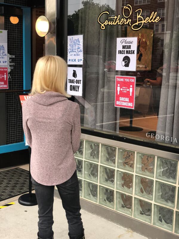 A customer waits for takeout outside Southern Belle. CONTRIBUTED BY WENDELL BROCK