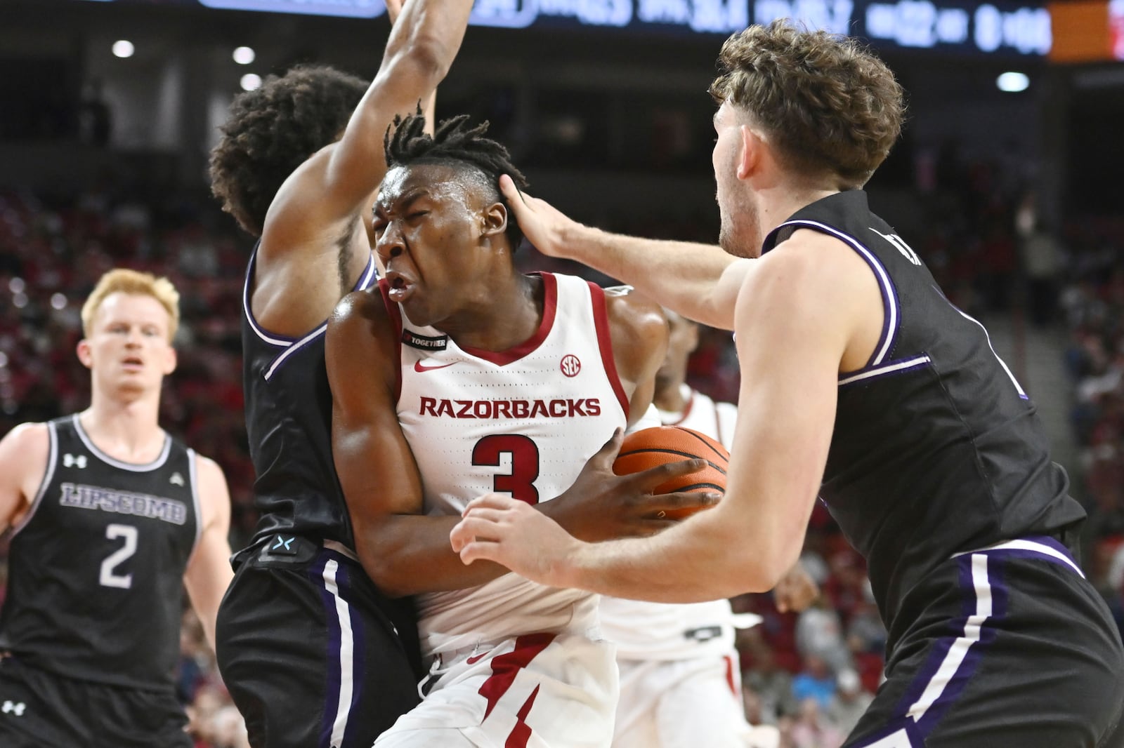 Arkansas forward Adou Thiero (3) is fouled by Lipscomb forward Rylan Houck, right, as he tries to drive to the basket during the second half of an NCAA college basketball game Wednesday, Nov. 6, 2024, in Fayetteville, Ark. (AP Photo/Michael Woods)