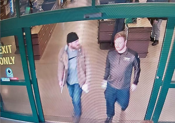 In this file image from a Jan. 1 surveillance video released by the U.S. Attorney's Office in Maryland, Brian Mark Lemley Jr., right, and Patrik Mathews leave a store in Delaware where they purchased ammunition and paper shooting targets. The pair, along with William Garfield Bilbrough IV, were arrested in January and are accused of plotting to commit violence at a Virginia gun rights rally.