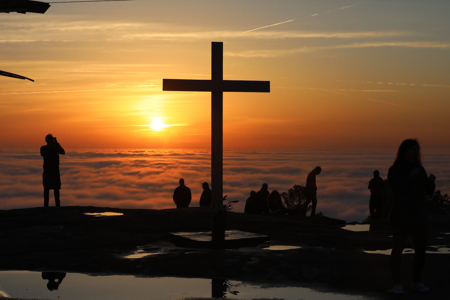 People enjoy the view on the top of Stone Mountain before starting the 76th annual Easter Sunrise Service on Sunday, April 17, 2022. The popular event returned to the park after a two-year hiatus because of the pandemic. Miguel Martinez/miguel.martinezjimenez@ajc.com