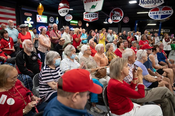 Attendees at a campaign stop held by Herschel Walker, the retired football star and Republican senate candidate, at a car dealership in rural in Ocilla, Georgia on July 19, 2022. The uneventful outing was noteworthy for Walker, whose candidacy has been rocked by a series of damaging reports about his business record and personal life.  (Nicole Craine/The New York Times)..