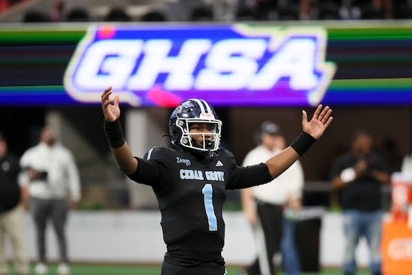 Cedar Grove quarterback Elliott Colson (1) reacts after throwing a touchdown pass during the second half against Savannah Christian in the Class 3A GHSA State Championship game at Mercedes-Benz Stadium, Wednesday, December. 13, 2023, in Atlanta. Cedar Grove won 49-28. (Jason Getz / Jason.Getz@ajc.com)