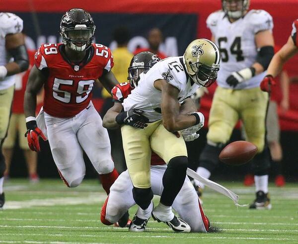 Falcons safety William Moore hits Saints wide receiver Marques Colston causing a fumble recovered by the Falcons in overtime in their NFL football game on Sunday, Sept. 7, 2014, in Atlanta. Falcons linebacker Joplo Bartu (left) recovered the fumble. The Falcons went on to kick a field goal to win the game 37-34. Moore could be back to face Cleveland on Nov. 23. (By Curtis Compton)