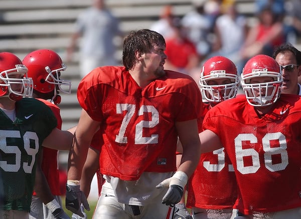 Georgia's Brian Jordan (No. 59) and Chris Abbott (69) escorts teammate Daniel Inman (72) off the field as he continues to yell at teammates Saturday, April 17, 2004 in Athens. (JOHNNY CRAWFORD/AJC file)