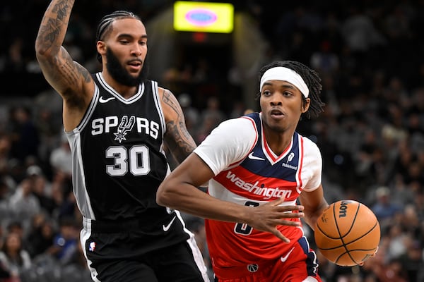 Washington Wizards' Bilal Coulibaly, right, drives against San Antonio Spurs' Julian Champagnie during the first half of an NBA basketball game, Thursday, Nov. 13, 2024, in San Antonio. (AP Photo/Darren Abate)