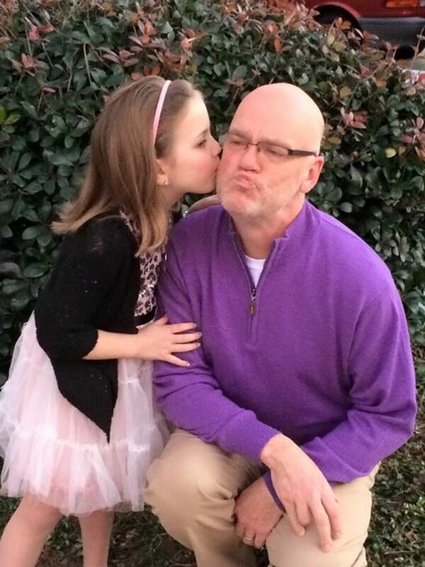 Katherine Bass plants a kiss on her dad’s cheek before a father-daughter dance at her school. Ken Adcox and his husband, Jim Bass, adopted Katherine and two of her siblings when Jim’s sister, a cocaine addict, could no longer care for them. CONTRIBUTED