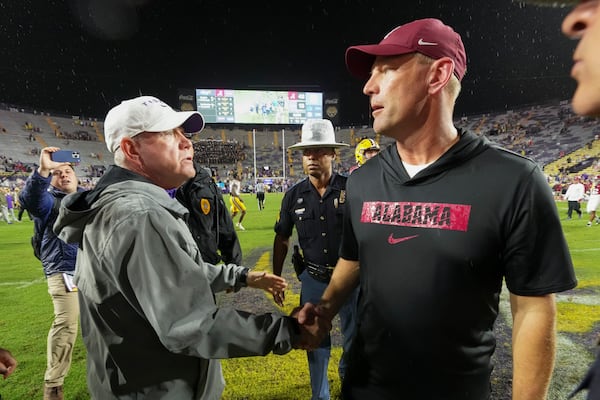 LSU head coach Brian Kelly, left, greets Alabama head coach Kalen DeBoer after an NCAA college football game in Baton Rouge, La., Saturday, Nov. 9, 2024. Alabama won 42-13. (AP Photo/Gerald Herbert)