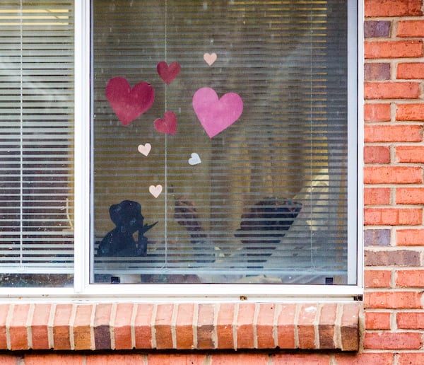 A resident is seen through a window at the Rosemont at Stone Mountain. In October, inspectors learned that the facility did not have a qualified infection prevention expert on staff. An inspection in December revealed that some workers weren’t wearing masks and face shields as required. (Jenni Girtman for The Atlanta Journal-Constitution)