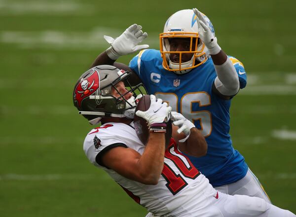 Tampa Bay Buccaneers wide receiver Scotty Miller (10) makes a catch on a pass by quarterback Tom Brady (12) for 44 yards, beating Los Angeles Chargers cornerback Casey Hayward Jr. (26) in the third quarter on Sunday, Oct. 4, 2020 at Raymond James Stadium in Tampa, Florida. Miller caught a pass for a touchdown on the following play. (Dirk Shadd/Tampa Bay Times/TNS)