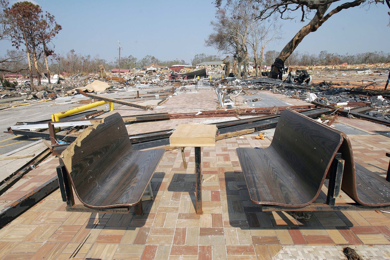 FILE - Only the benches remain at what was a Waffle House restaurant on the beachfront area in Gulfport, Miss., Sept. 20, 2005, following Hurricane Katrina. (AP Photo/Ric Feld, File)