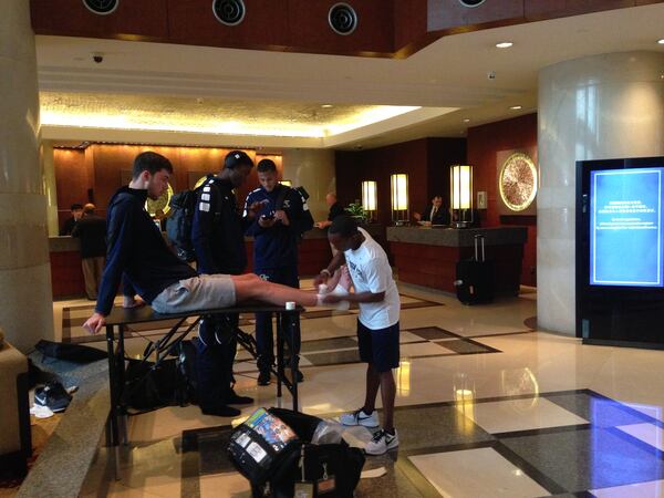 Georgia Tech forward Evan Cole gets his ankles taped by Tech trainer Richard Stewart in the lobby of the Hyatt Regency Hangzhou prior to a practice that was ultimately canceled because of a police investigation that ultimately led to the arrest of three UCLA players.