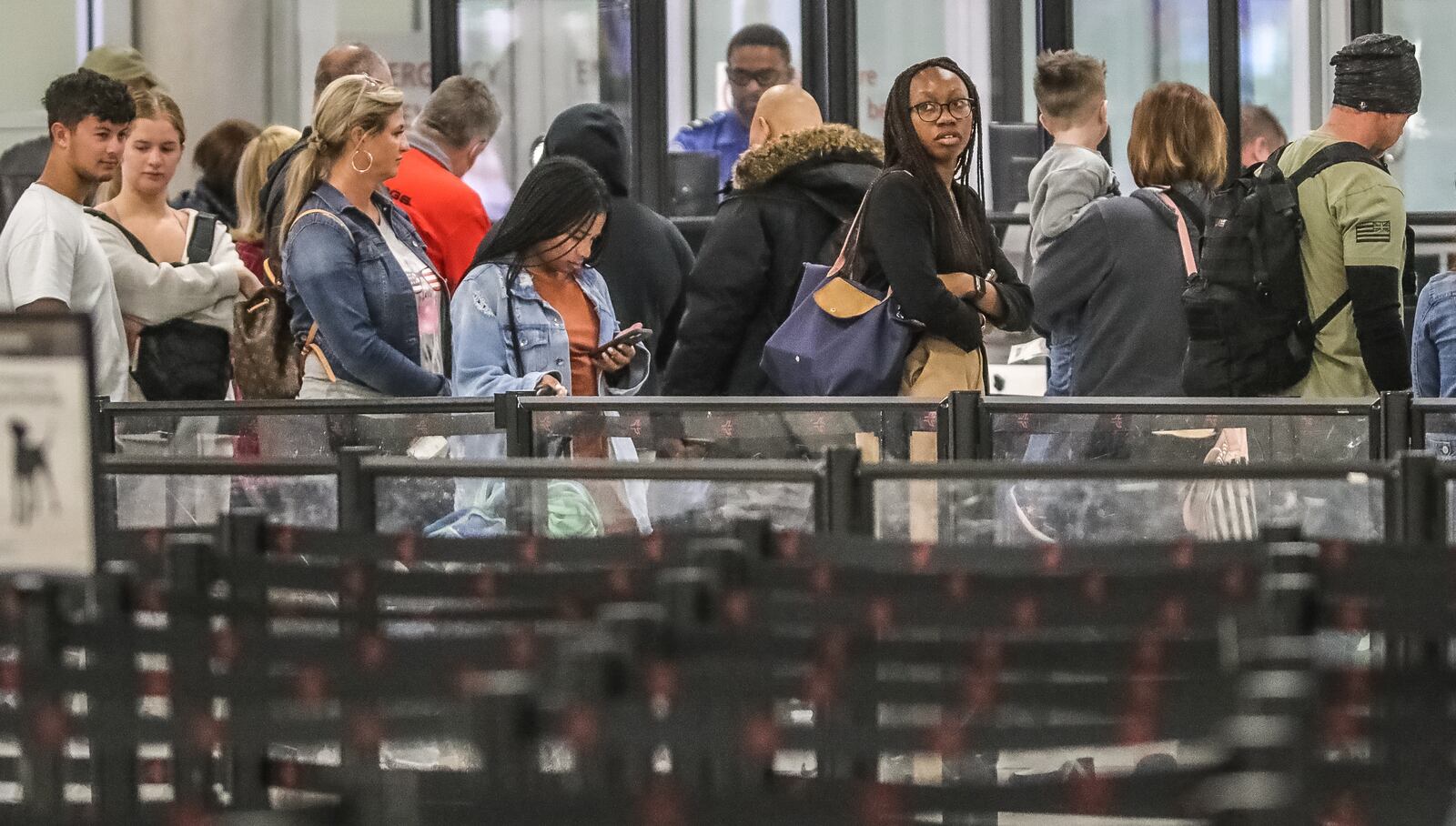 Passengers wait in line at Hartsfield-Jackson as a nationwide FAA system failure has caused delays and some cancelations for some flights.