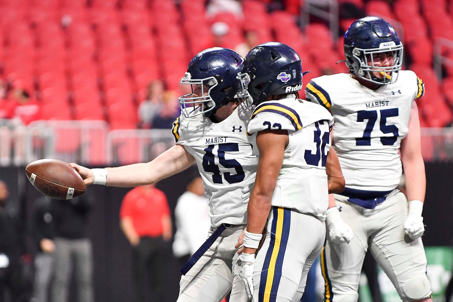 Marist’s Parks Kaiser (45) celebrates with Brayden Lewis (32) and Brady Barry (75) after carrying the ball into North Oconee’s end zone for a War Eagle touchdown during the first half of a Class 4A championship game at the Mercedes-Benz Stadium Monday, Dec. 16, 2024. (Photo/Daniel Varnado)