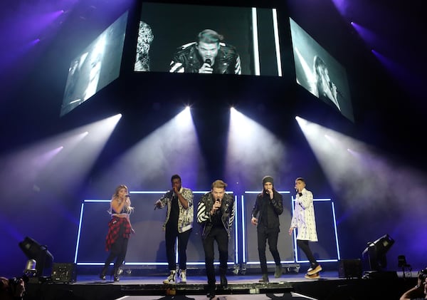 Scott Hoying, Mitchell Grassi, Kirstin Maldonado, Avi Kaplan and Kevin Olusola with Pentatonix performs at the Infinite Energy Arena on Wednesday, November 16, 2016, in Atlanta. (Photo by Robb Cohen/Invision/AP)