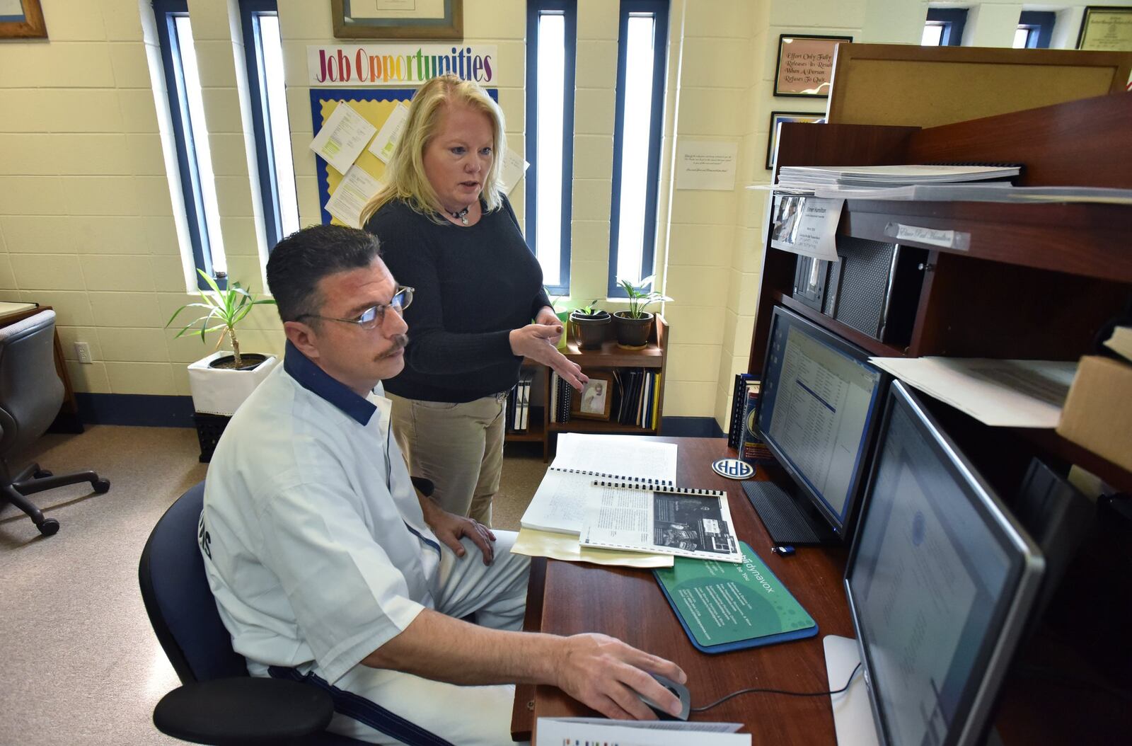 October 26, 2017 — Angie Scott, director of the braille transcription program at Central State Prison in Macon, talks to Elmer Hamilton, an inmate and certified braille transcriber. HYOSUB SHIN / HSHIN@AJC.COM