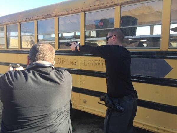 Lt. Sidney Harrisonon of the Laurens County Sheriff's Department, left and Curt Kersey, safety coordinator for Laurens County schools give demonstrations during active shooter training for armed school staff. Courtesy of Laurens County School District