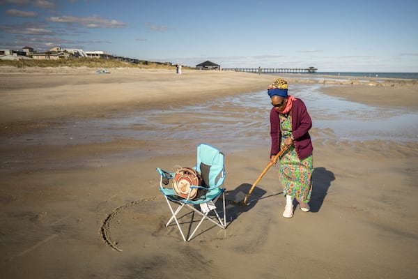 Julia Pearce, who's running for may of Tybee Island, draws a full circle around her beach chair as an invitation for friends to join her spot on the beach. Pearce is a well-known activist for the island's Black history, and she said she draws a circle as an acknowledgment to her community and her ancestors. (AJC Photo/Stephen B. Morton)