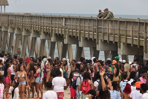 Game wardens from the Georgia Department of Natural Resources patrol from Tybee Island Pier as attendees of Orange Crush party on the beach on Saturday, April 20, 2024. The island put various traffic and safety protocols in place in anticipation of large crowds in town Orange Crush, an annual spring break gathering for college students. (Natrice Miller/ AJC)