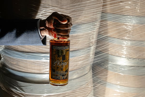 Victor Yarbrough, CEO of Brough Brothers Distillery holds of bottle of the company's product in Louisville, Ky., Saturday, March 8, 2025. (AP Photo/Jon Cherry)