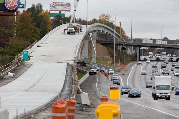 Workers prepare part of a bridge near Delk Road, part of the new Northwest Corridor Express Lanes. (Photo by Phil Skinner)