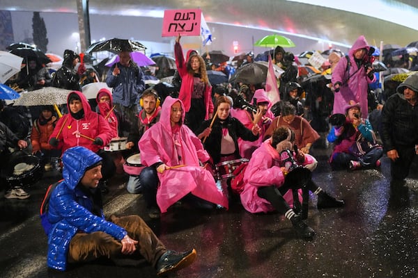 Demonstrators block a road during a protest against Israeli Prime Minister Benjamin Netanyahu's plan to dismiss the head of the Shin Bet internal security service, in Jerusalem on Thursday, March 20, 2025. (AP Photo/Ohad Zwigenberg)