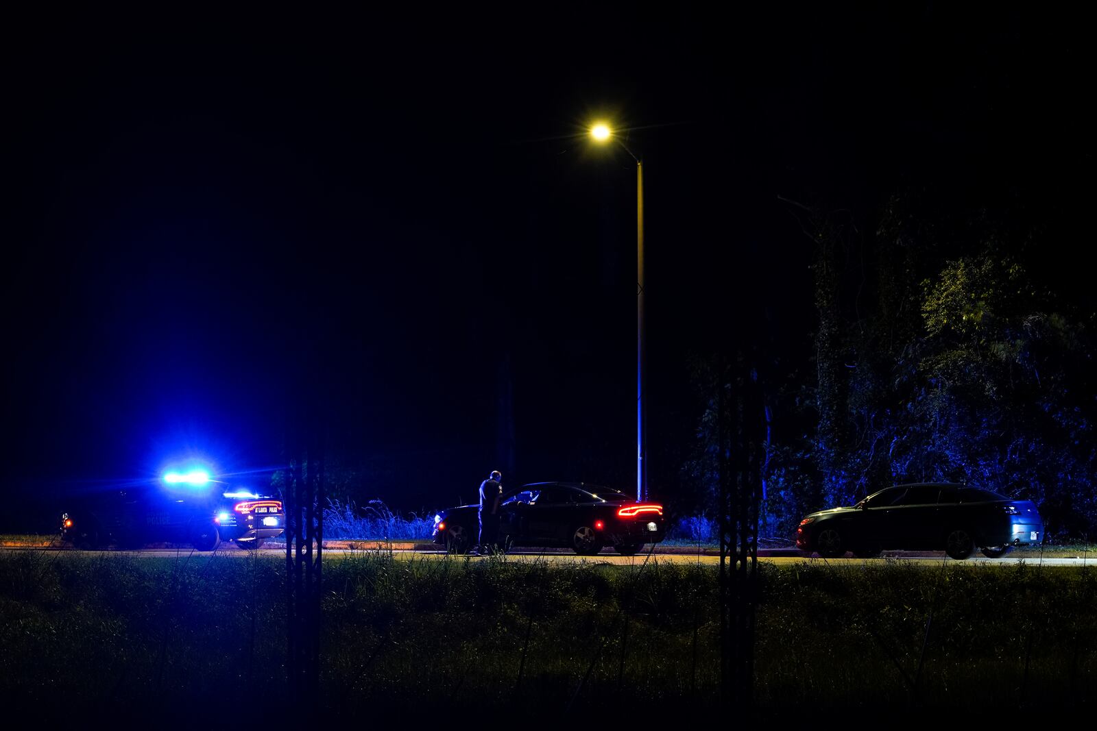 Atlanta police officers are seen on Benjamin E. Mays Drive after a shooting early Sunday.